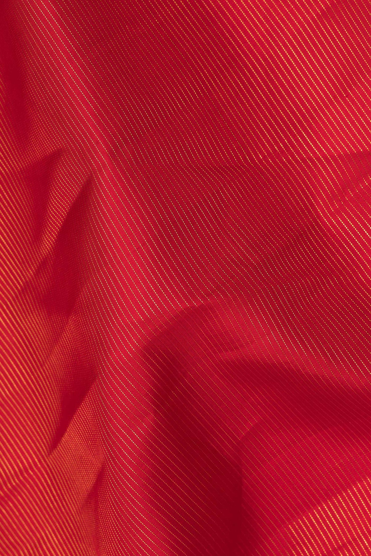 Close up of Pure Silk Red Dual Tone Kanjivaram Saree with Stripes on the body and Zari Border.  displaying folds