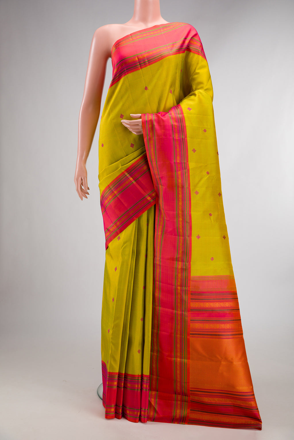 Pure Silk Mehandi Green Dual Tone Kanjivaram Saree with Thread Butta on the body and Thread Border.  displayed on a mannequin