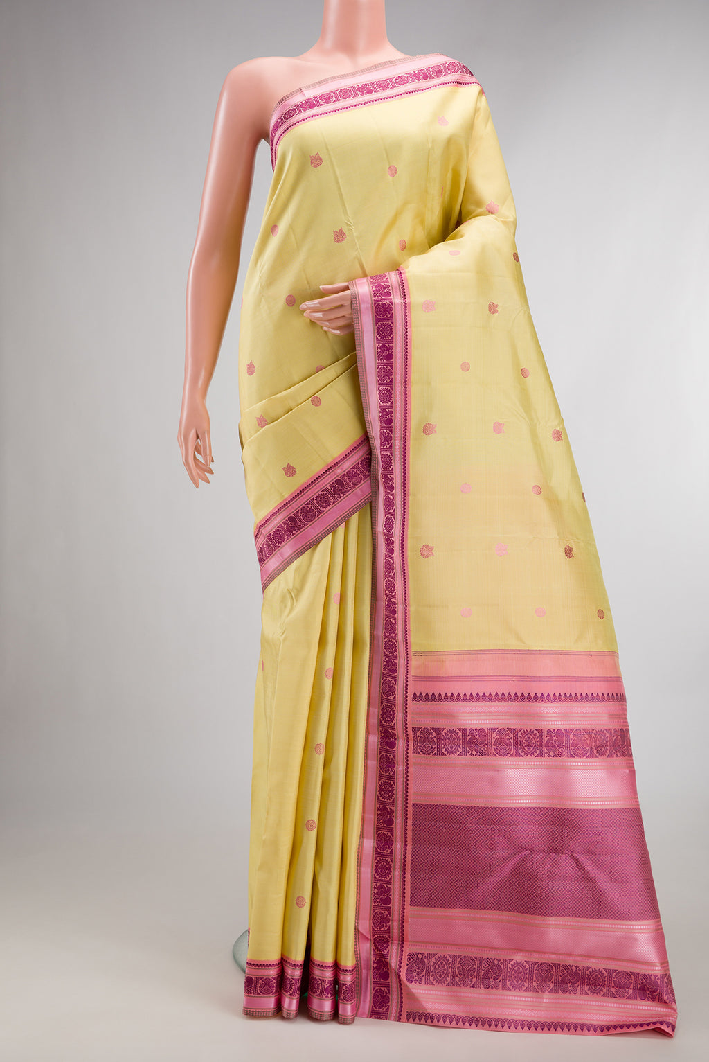 Pure Silk Sandal Kanjivaram Saree with Thread Butta on the body and Thread Border.  displayed on a mannequin