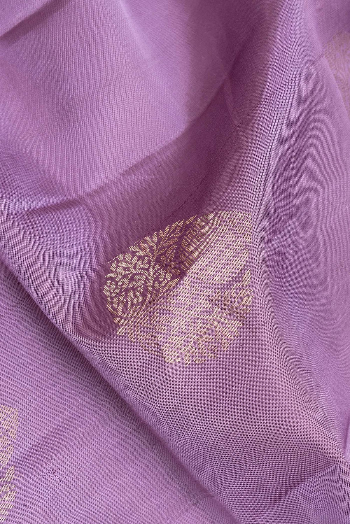 Close up of Pure Silk Purple Dual Tone Soft Saree with Zari Butta on the body and Zari Border.  displaying folds
