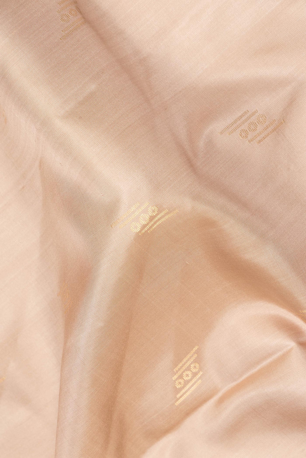 Close up of Pure Silk Dark Beige Dual Tone Soft Saree with Zari Butta on the body and Zari Border.  displaying folds