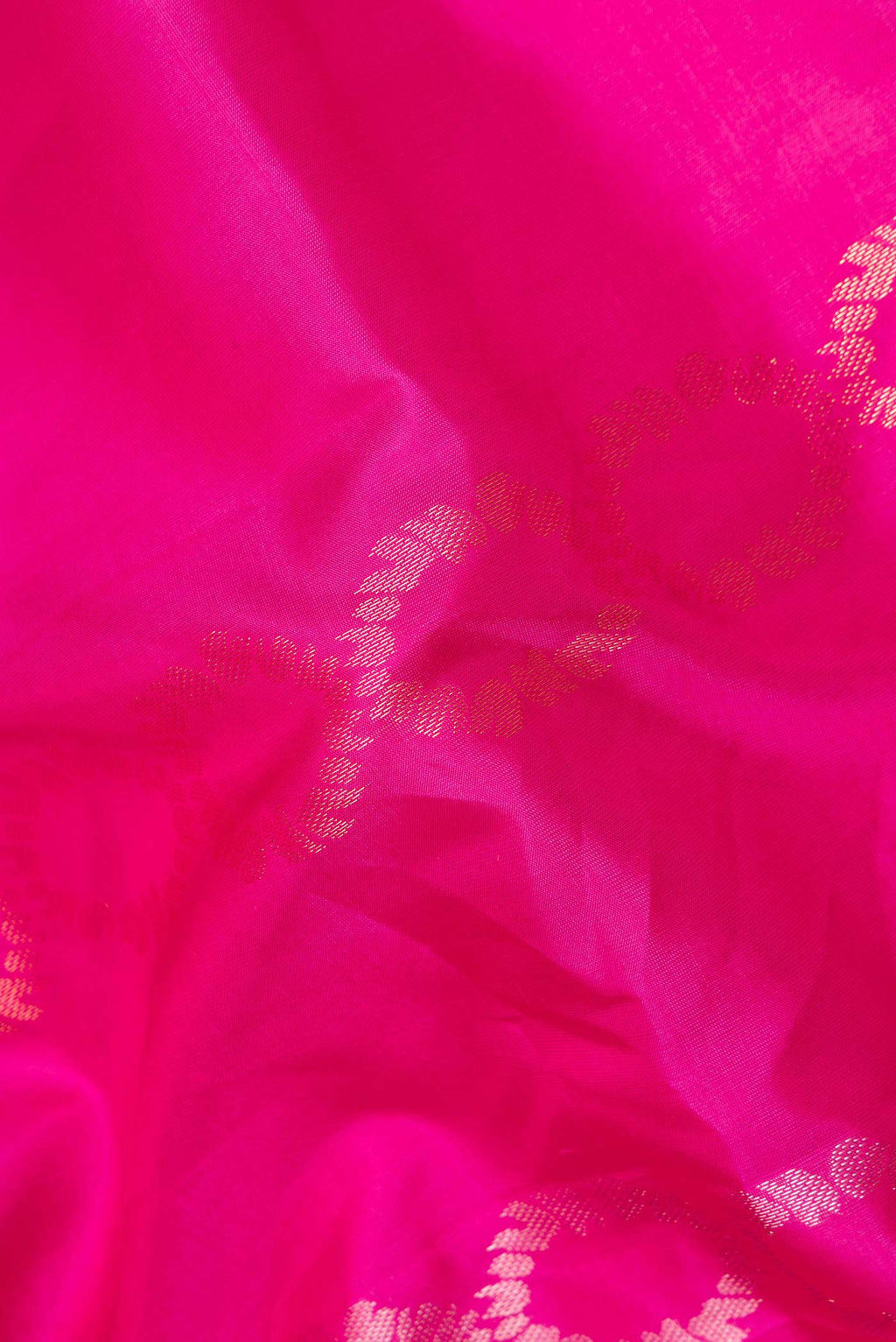 Close up of Pure Silk Dark Pink Dual Tone Soft Saree with Zari Butta on the body and Zari Border.  displaying folds