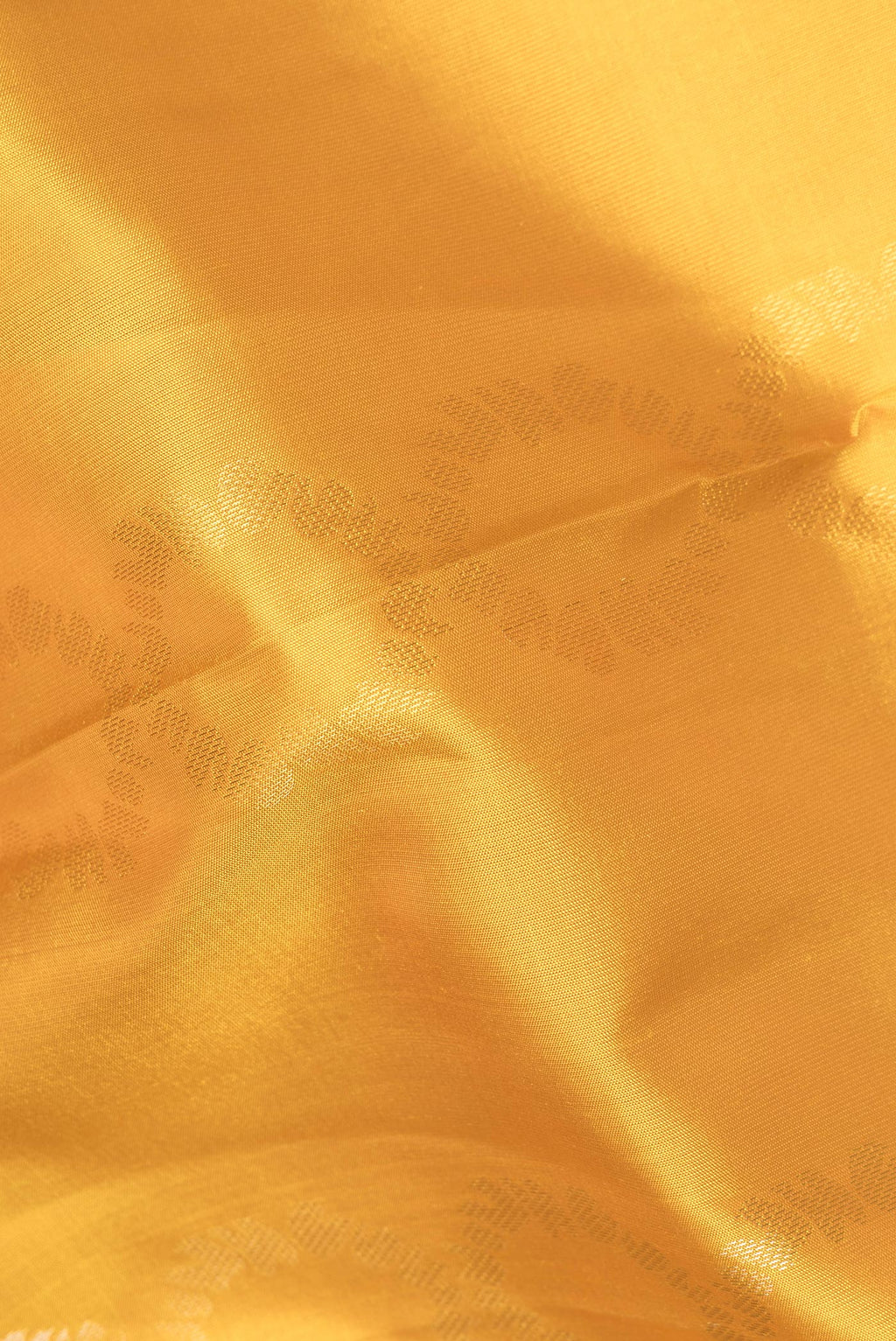 Close up of Pure Silk Mustard Dual Tone Soft Saree with Zari Butta on the body and Zari Border.  displaying folds