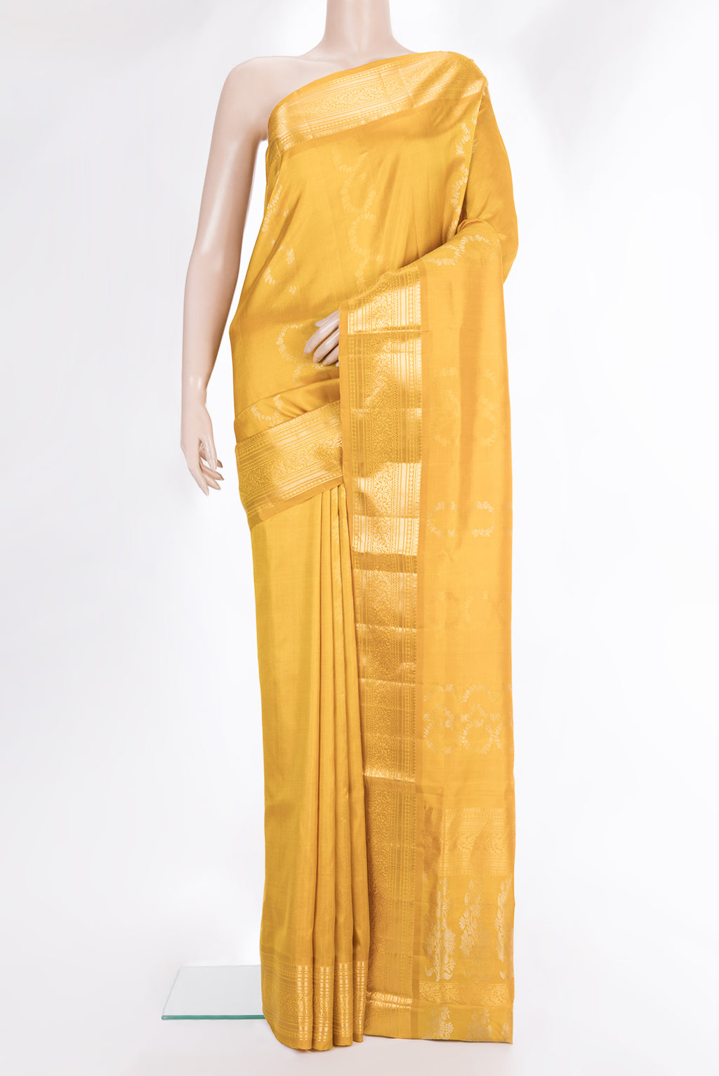 Pure Silk Mustard Dual Tone Soft Saree with Zari Butta on the body and Zari Border.  displayed on a mannequin