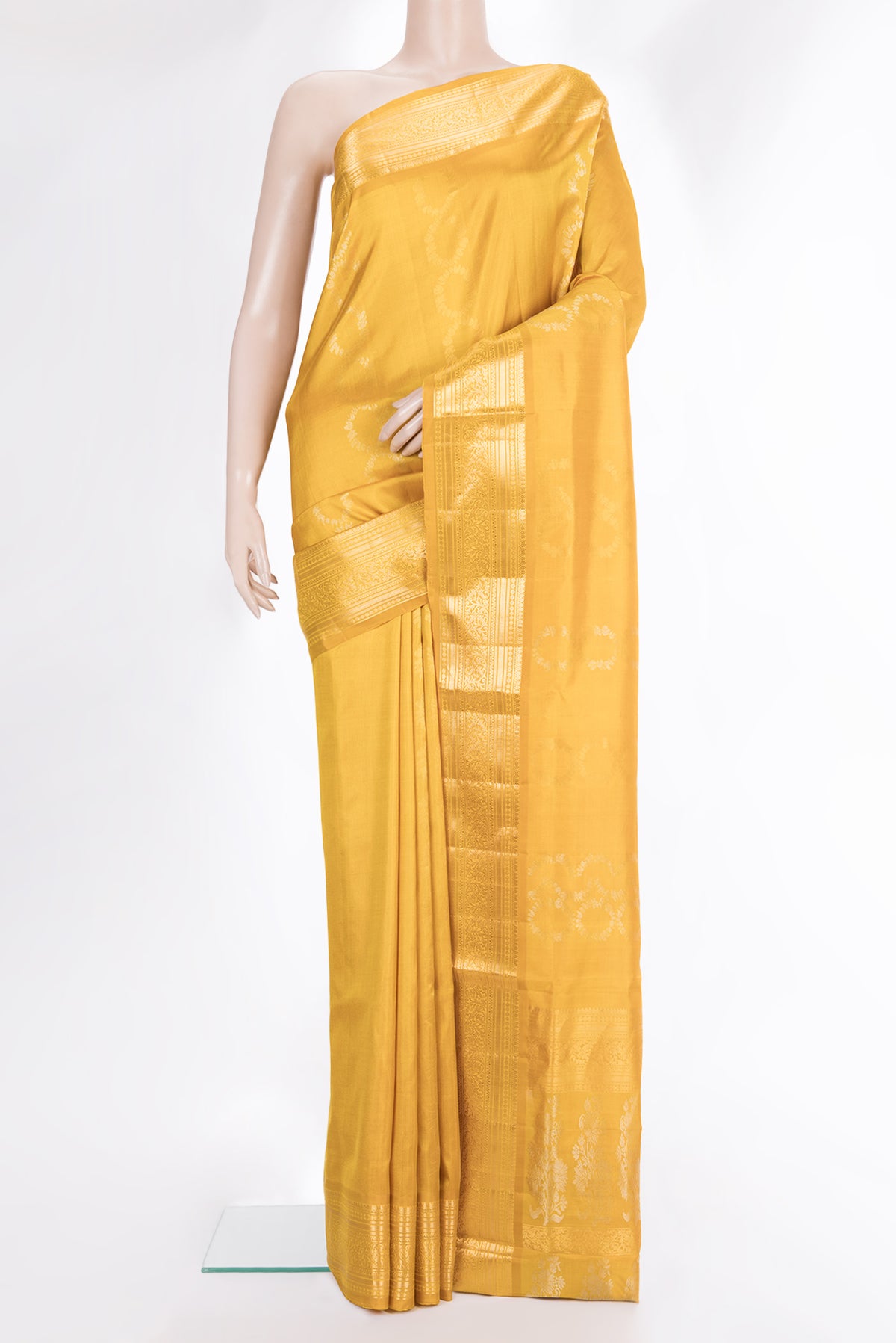 Pure Silk Mustard Dual Tone Soft Saree with Zari Butta on the body and Zari Border.  displayed on a mannequin