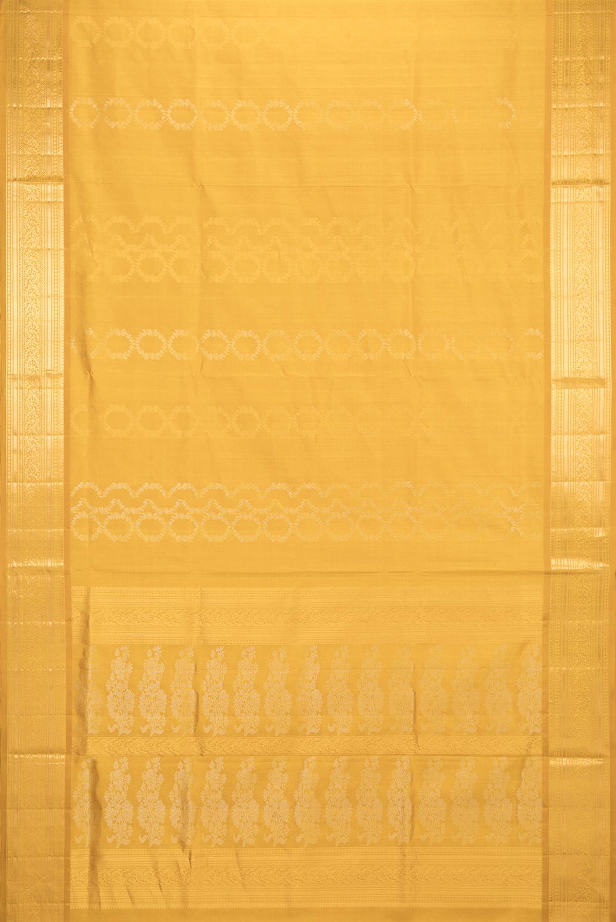 Flat view of Pure Silk Mustard Dual Tone Soft Saree with Zari Butta on the body and Zari Border. 