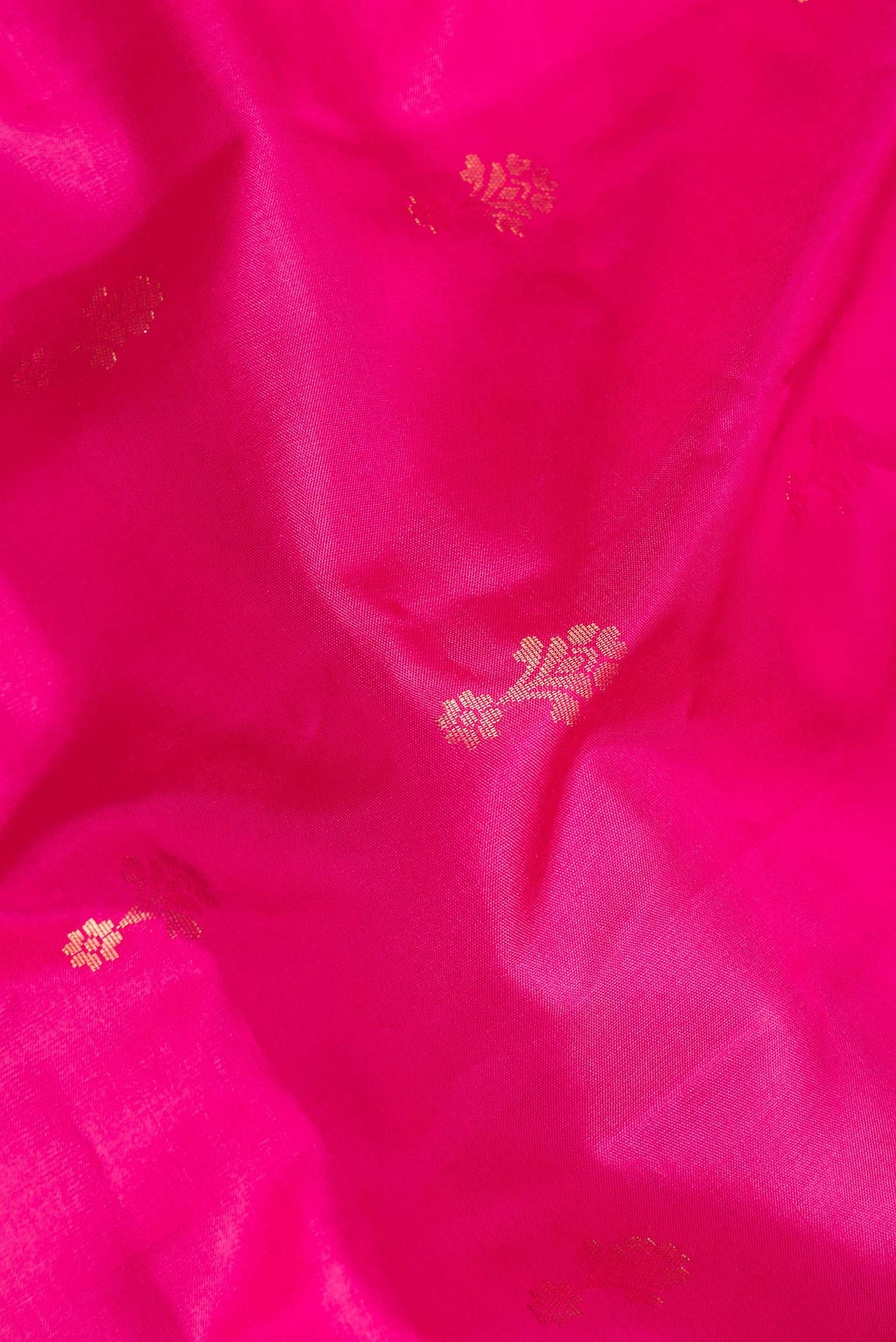 Close up of Pure Silk Pink Dual Tone Soft Saree with Zari Butta on the body and Zari Border.  displaying folds