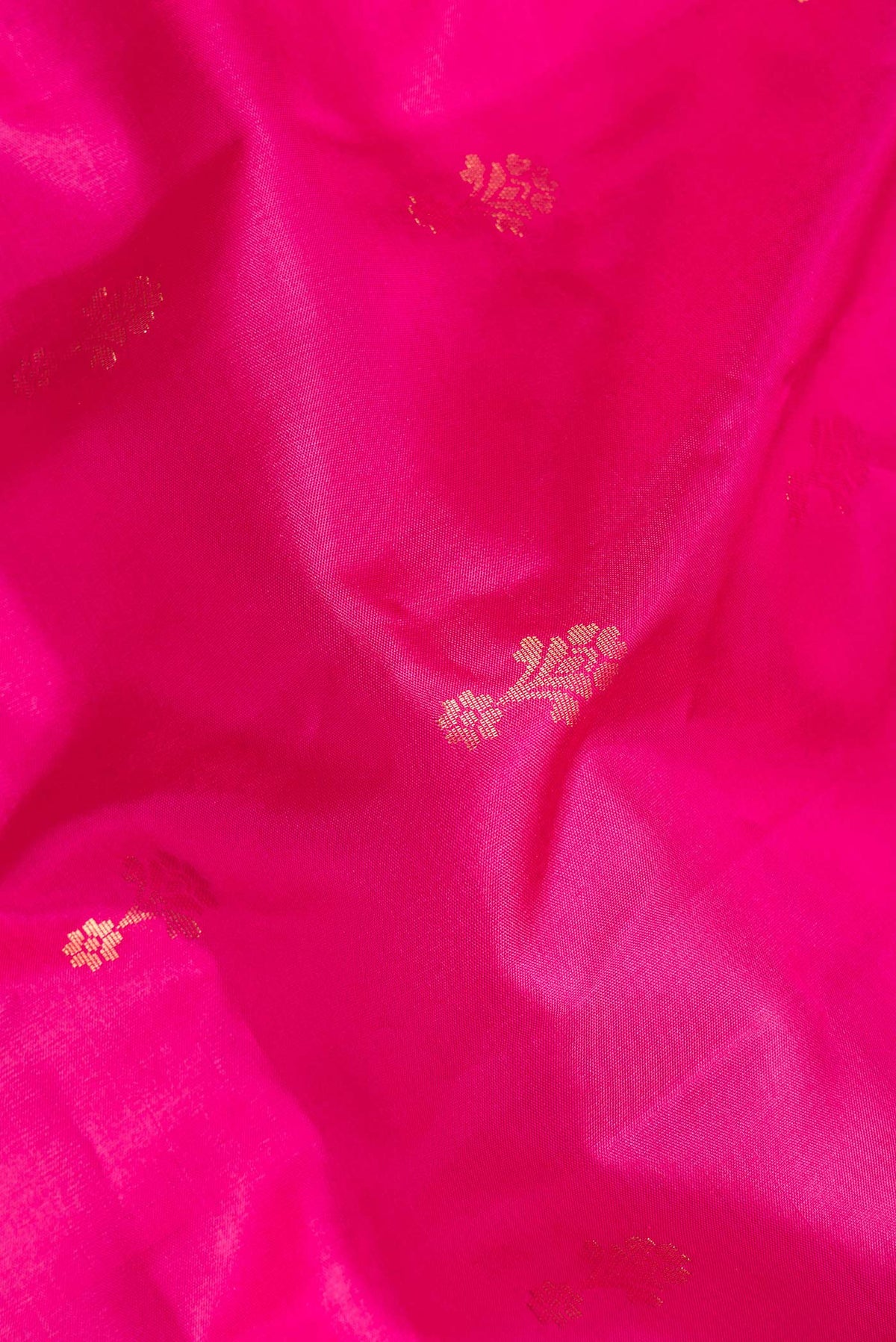 Close up of Pure Silk Pink Dual Tone Soft Saree with Zari Butta on the body and Zari Border.  displaying folds