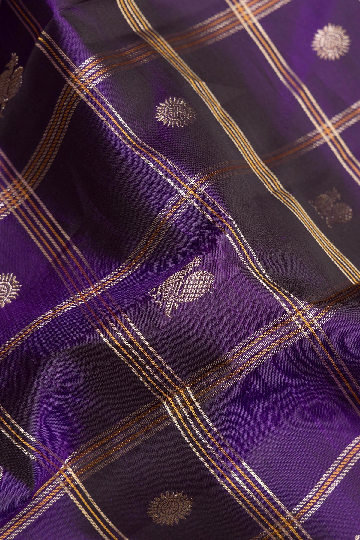 Close up of Pure Silk Violet Kanchipuram Saree with Checked design on the body and Zari Border.  displaying folds