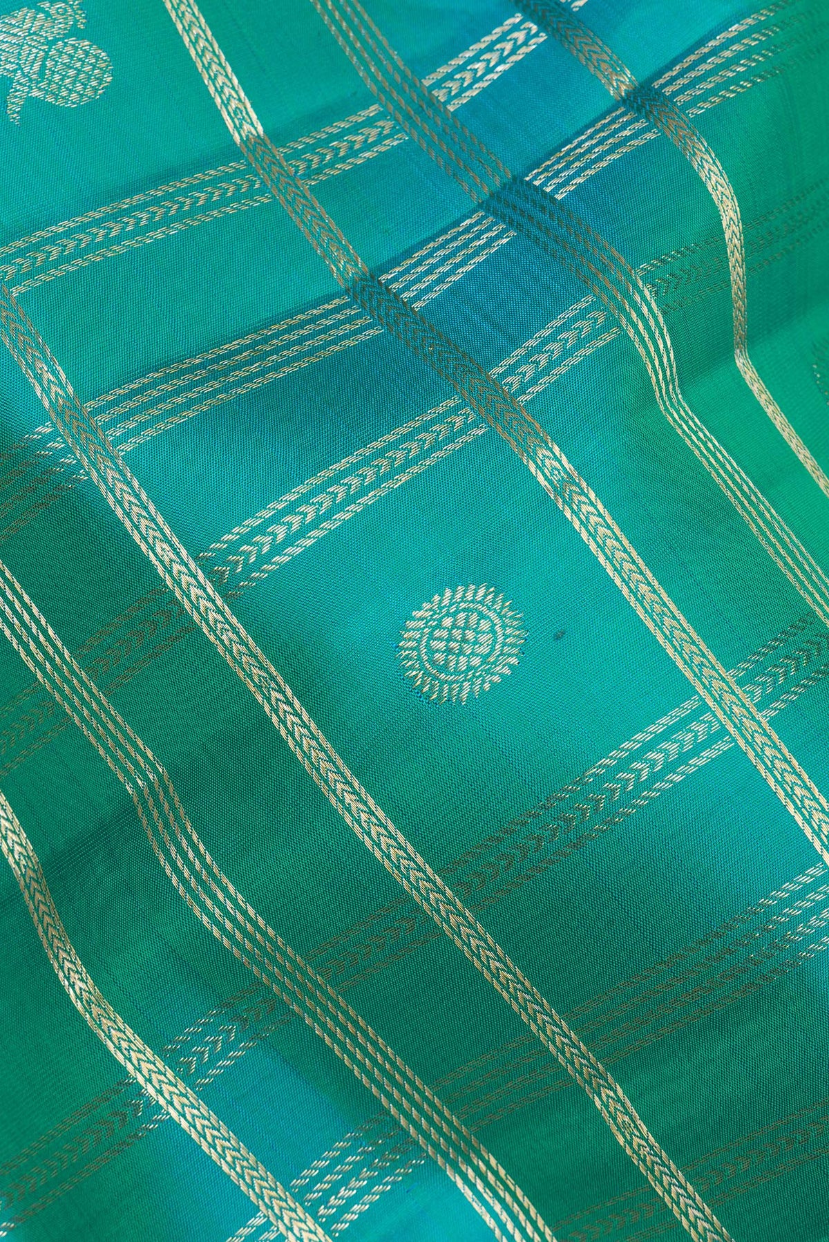 Close up of Pure Silk Sea Green Dual Tone Kanchipuram Saree with Checked design on the body and Zari Border.  displaying folds