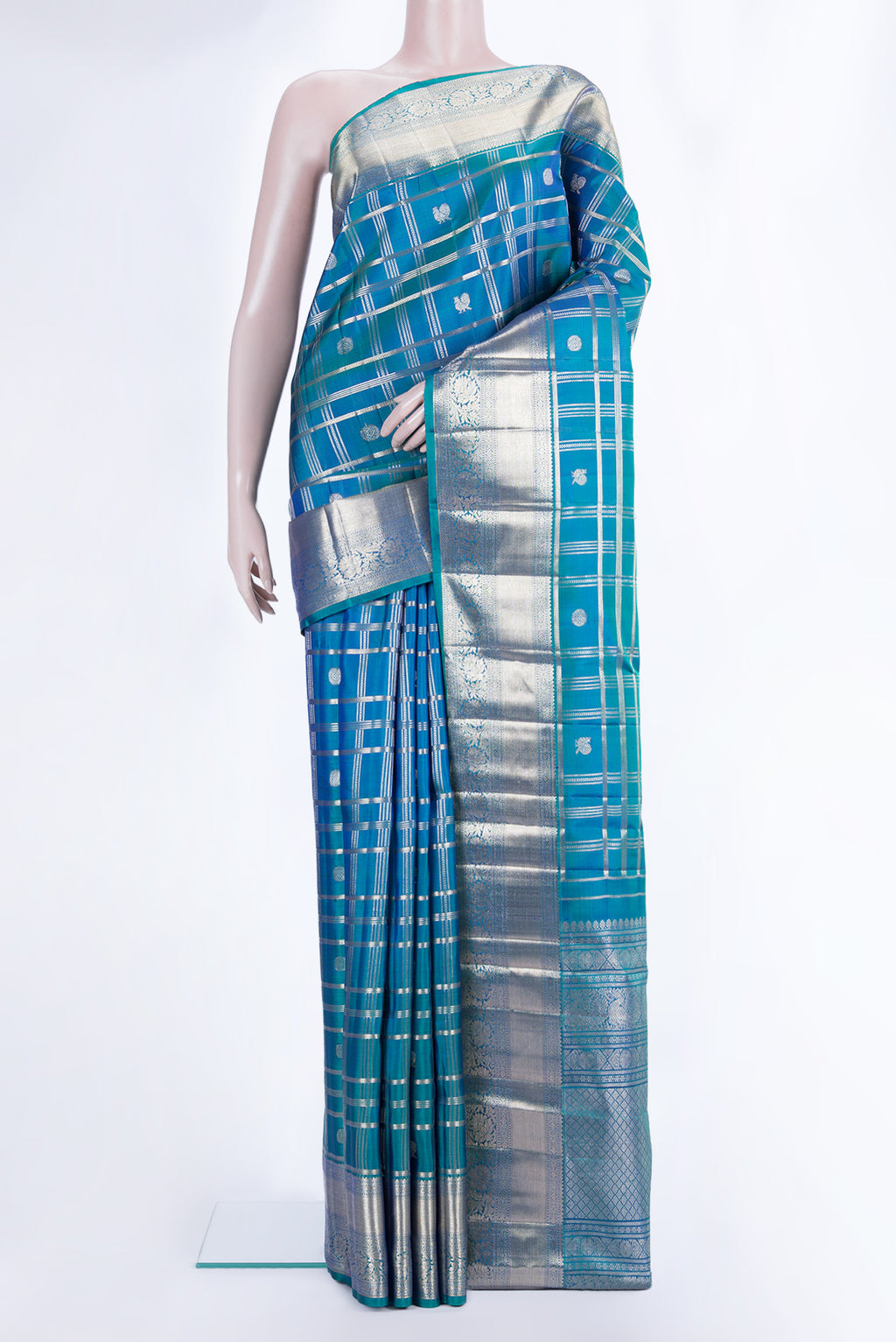 Pure Silk Peacock Blue Dual Tone Kanchipuram Saree with Checked design on the body and Zari Border.  displayed on a mannequin