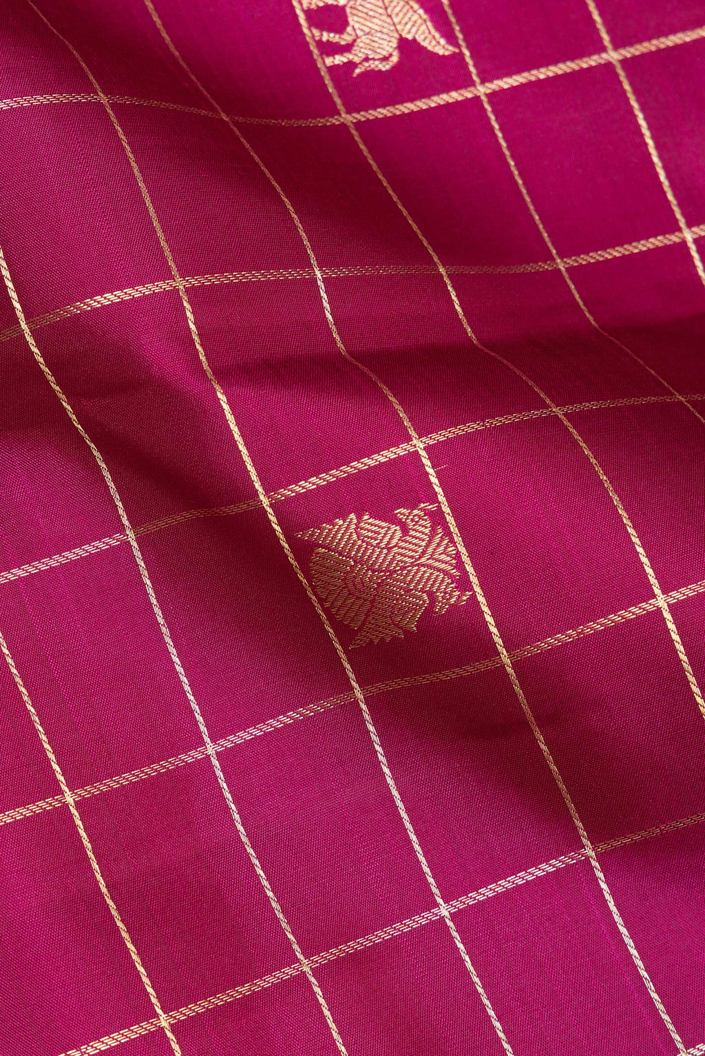 Close up of Pure Silk Magenta Dual Tone Kanchipuram Saree with Checked design on the body and Zari Border.  displaying folds