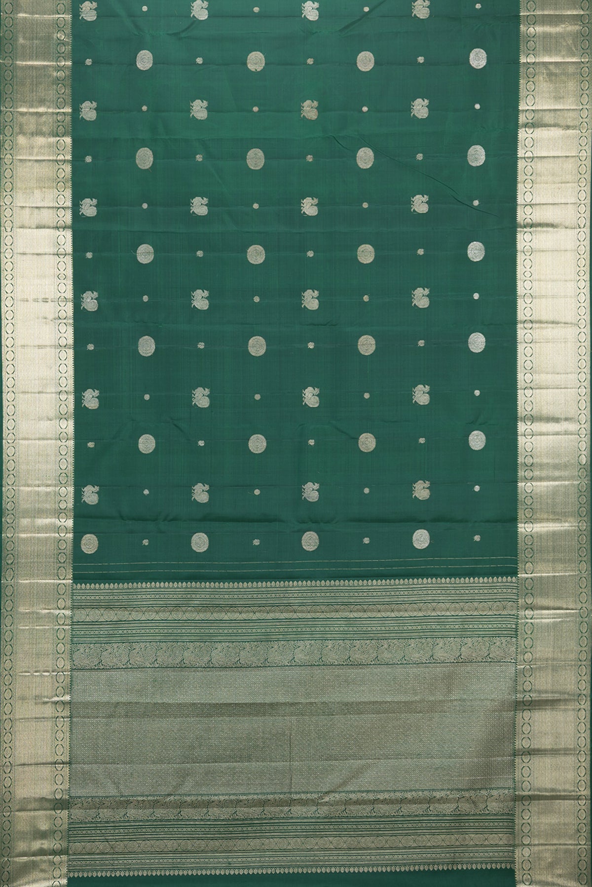 Flat view of Pure Silk Bottle Green Kanjivaram Saree with Zari Butta on the body and Zari Border. 