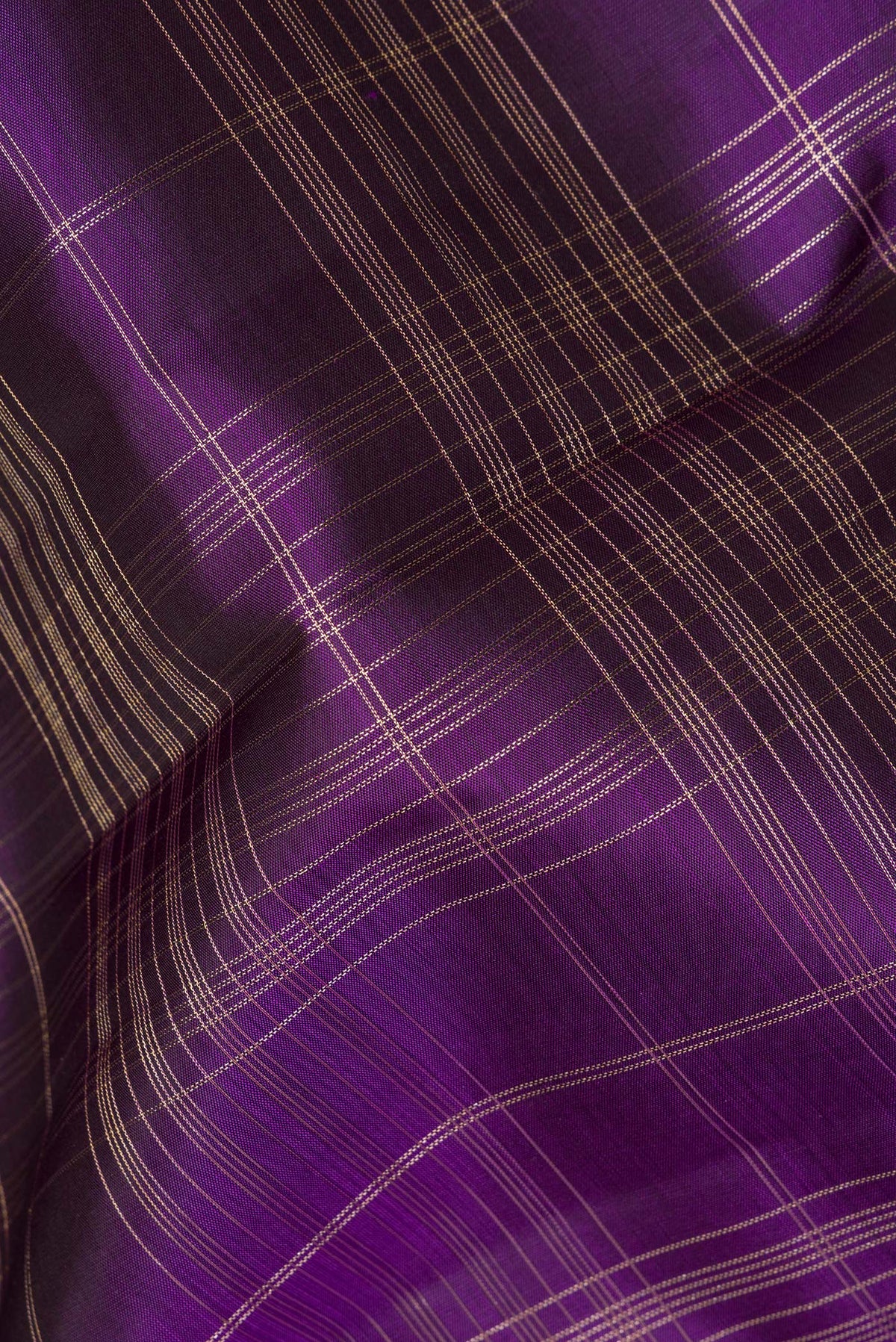 Close up of Pure Silk Purple Dual Tone Kanchipuram Saree with Checked design on the body and Zari Border.  displaying folds