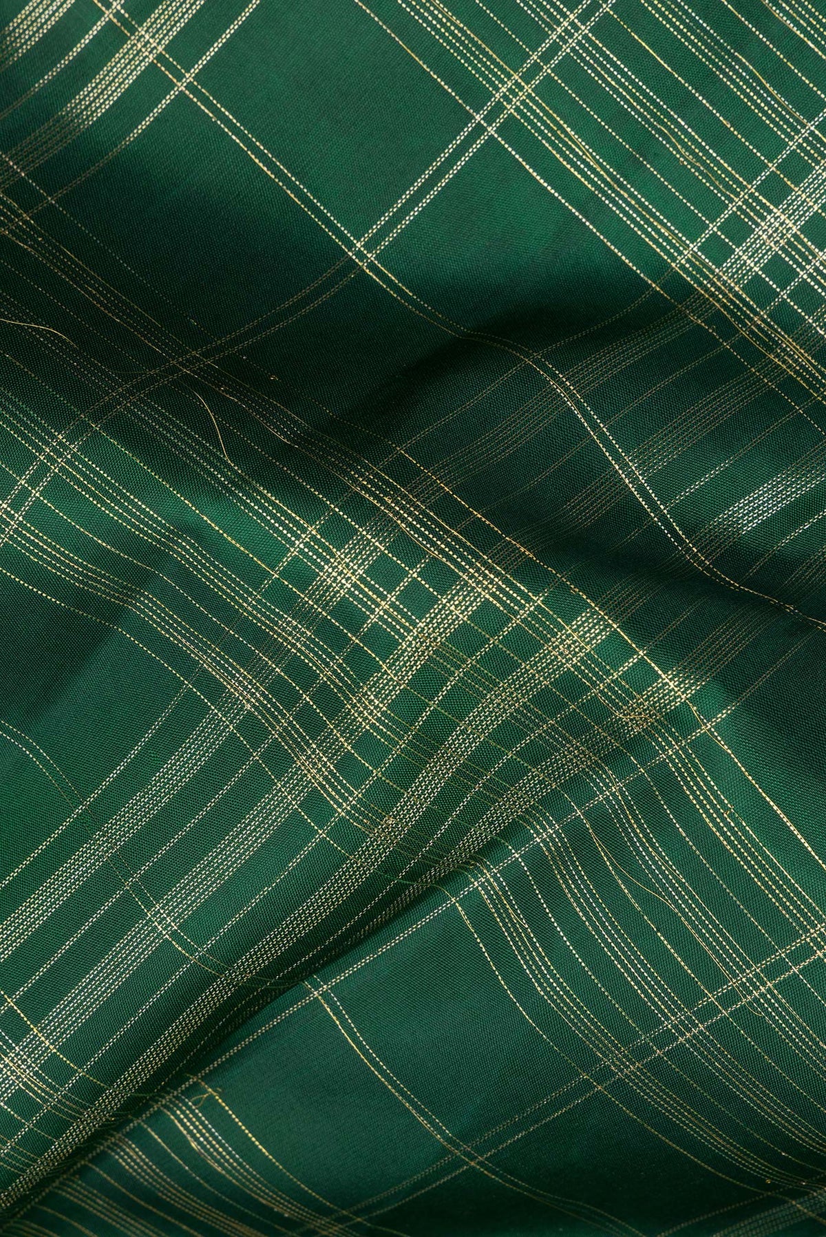 Close up of Pure Silk Bottle Green Kanchipuram Saree with Checked design on the body and Zari Border.  displaying folds