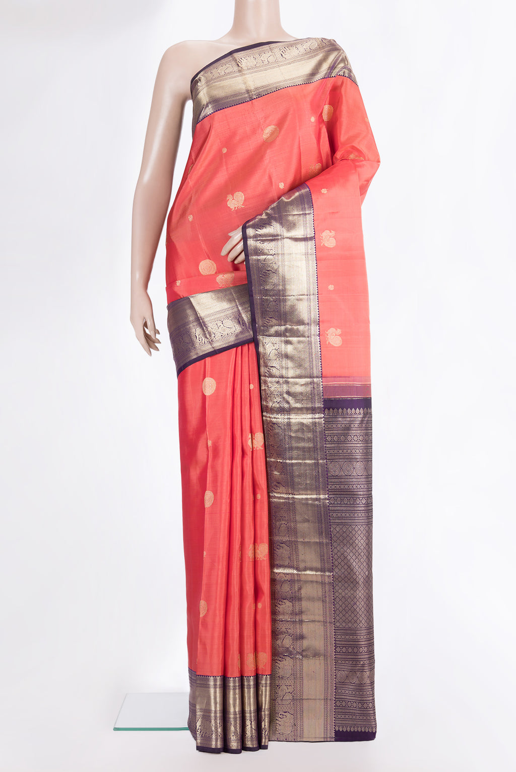 Pure Silk Brick Orange Kanchipuram Saree with Zari Butta on the body and Zari Border.  displayed on a mannequin