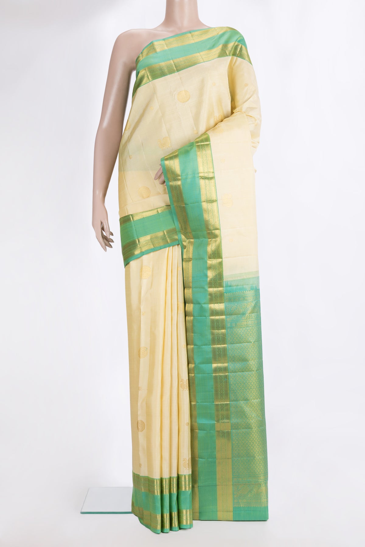 Pure Silk Cream Kanchipuram Saree with Zari Butta on the body and Zari Border.  displayed on a mannequin