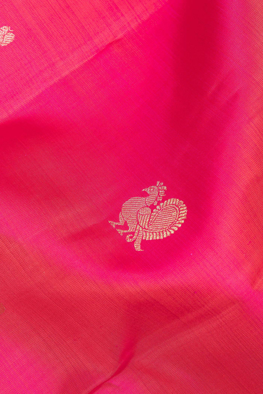 Close up of Pure Silk Pink Dual Tone Kanchipuram Saree with Zari Butta on the body and Zari Border.  displaying folds