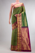 Pure Silk Bottle Green Kanjivaram Saree with Zari Brocade on the body and Fancy Border.  displayed on a mannequin