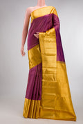 Pure Silk Magenta Kanchipuram Saree with Zari Brocade on the body and Zari Border.  displayed on a mannequin