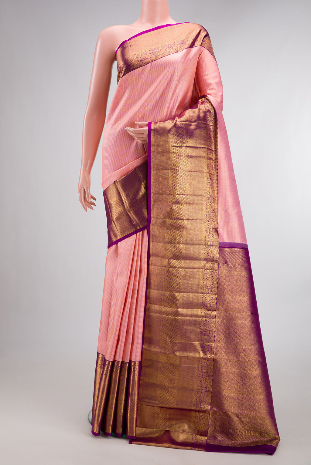Pure Silk Peach Kanchipuram Saree with Zari Brocade on the body and Zari Border.  displayed on a mannequin