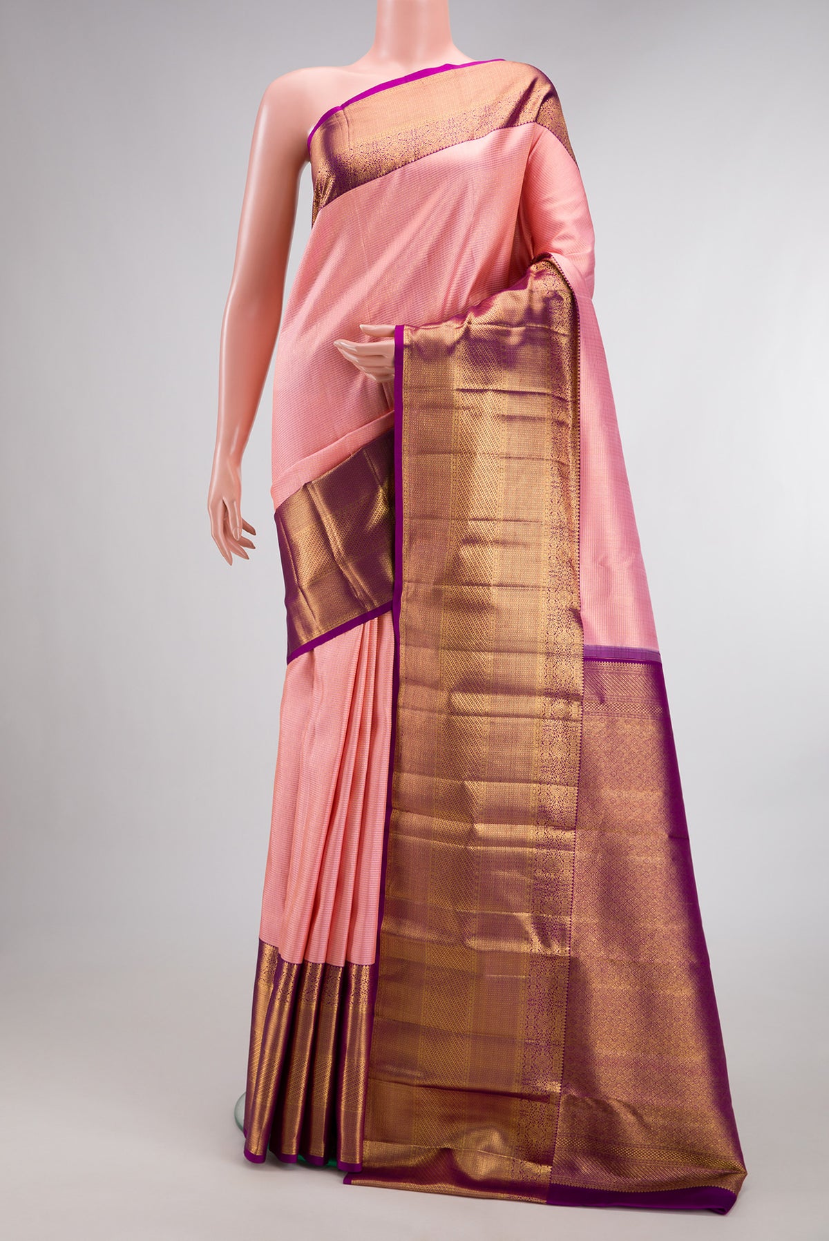 Pure Silk Peach Kanchipuram Saree with Zari Brocade on the body and Zari Border.  displayed on a mannequin