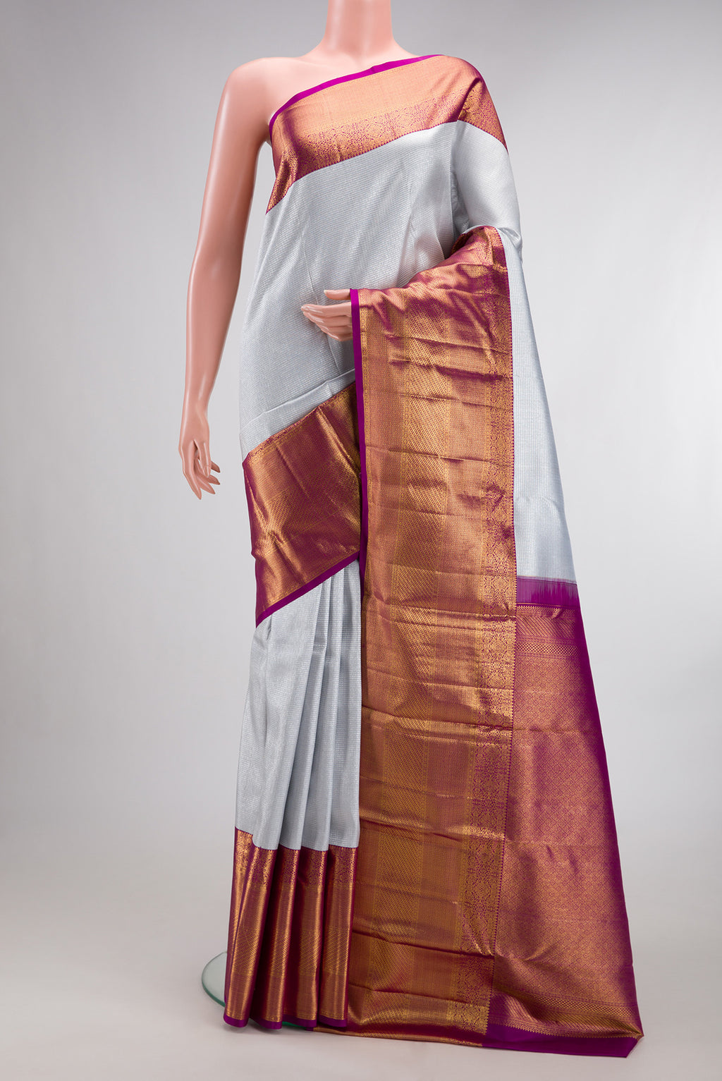 Pure Silk Silver Kanchipuram Saree with Zari Brocade on the body and Zari Border.  displayed on a mannequin