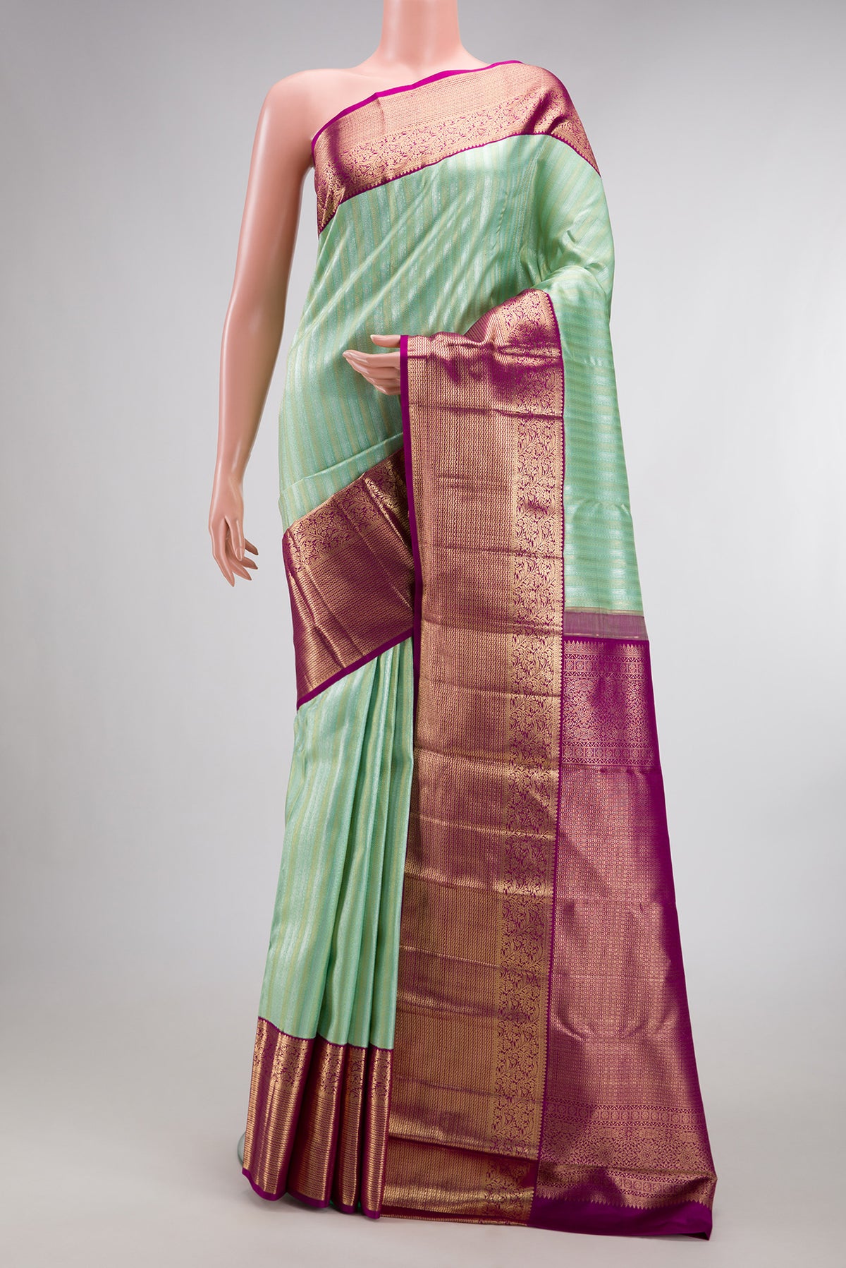 Pure Silk Pista Green Kanchipuram Saree with Zari Brocade on the body and Zari Border.  displayed on a mannequin