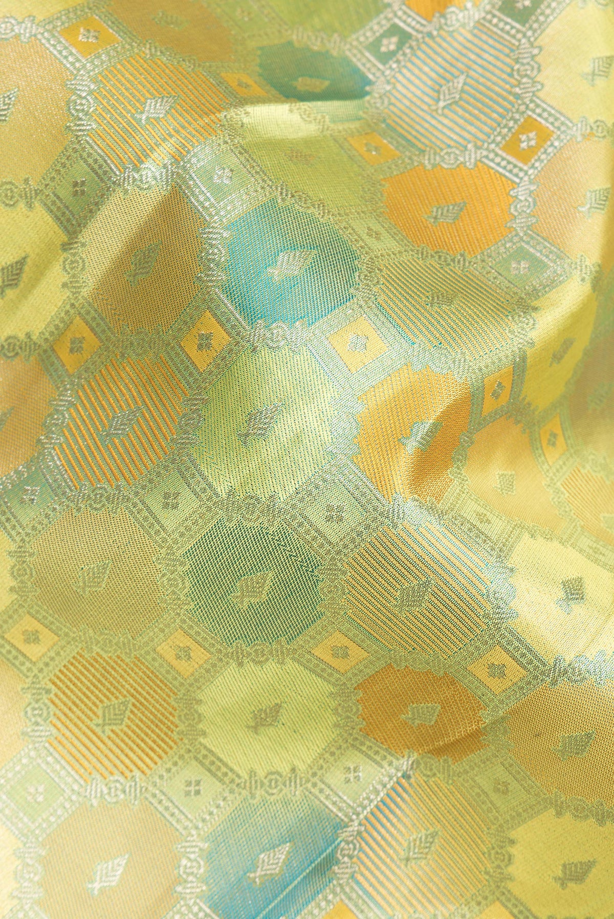 Close up of Pure Silk Pista Green Dual Tone Kanjivaram Saree with Zari Brocade on the body and Zari Border.  displaying folds