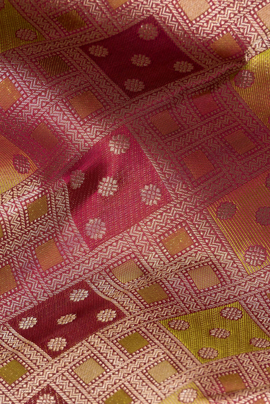 Close up of Pure Silk Maroon Kanjivaram Saree with Zari Brocade on the body and Zari Border.  displaying folds