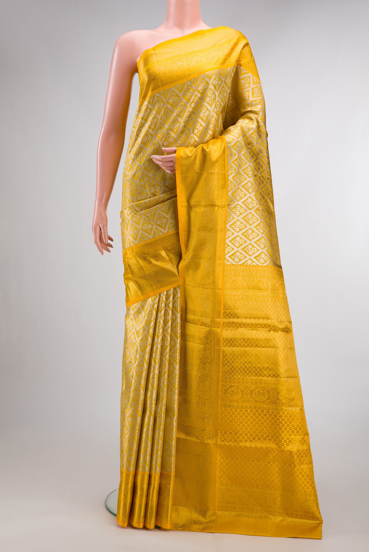 Yellow Dual Tone Kanjivaram Tissue Saree with Zari Brocade on the body and Zari Border.  displayed on a mannequin