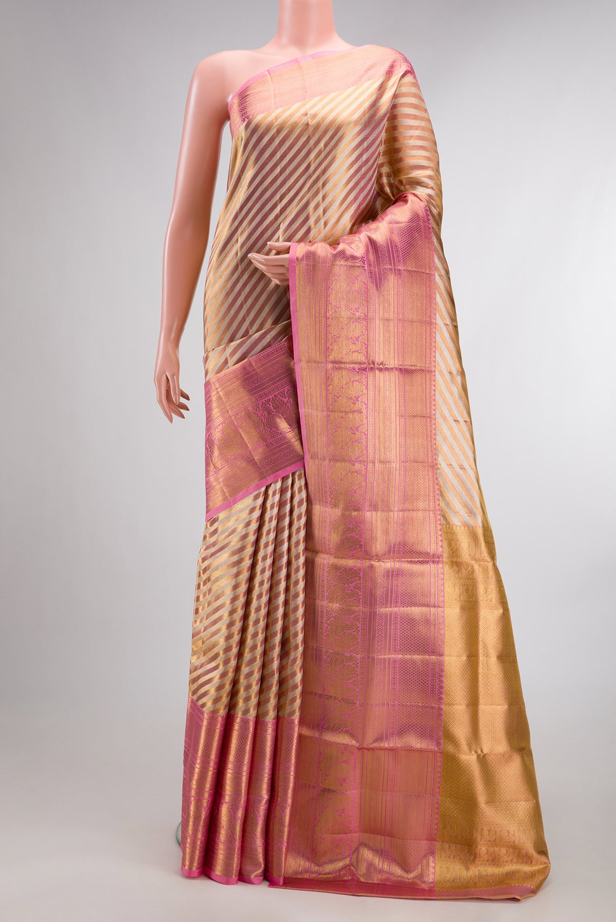 Gold Dual Tone Kanjivaram Tissue Saree with Zari Brocade on the body and Fancy Border.  displayed on a mannequin