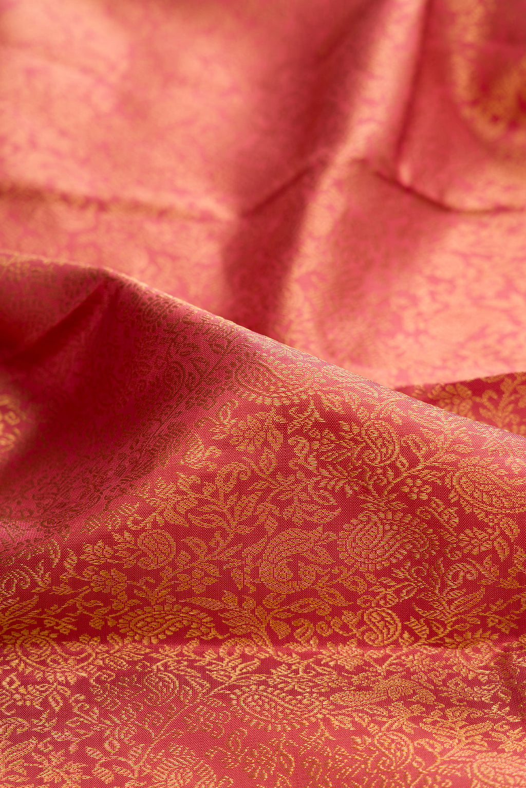 Close up of Pure Silk Peach Kanchipuram Saree with Zari Brocade on the body and Zari Border.  displaying folds