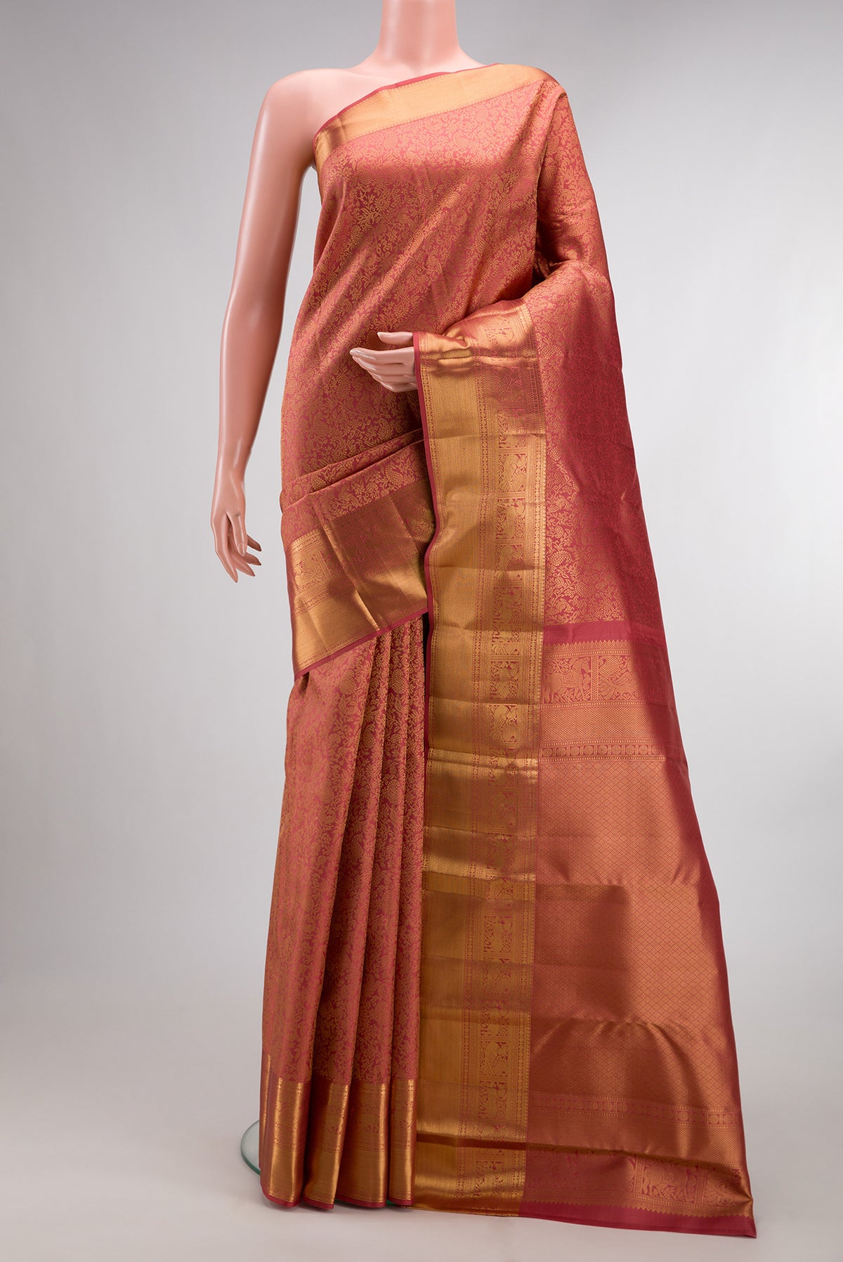Pure Silk Peach Kanchipuram Saree with Zari Brocade on the body and Zari Border.  displayed on a mannequin