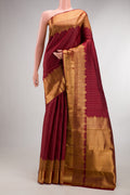 Pure Silk Maroon Kanjivaram Saree with Zari Butta on the body and Fancy Border.  displayed on a mannequin