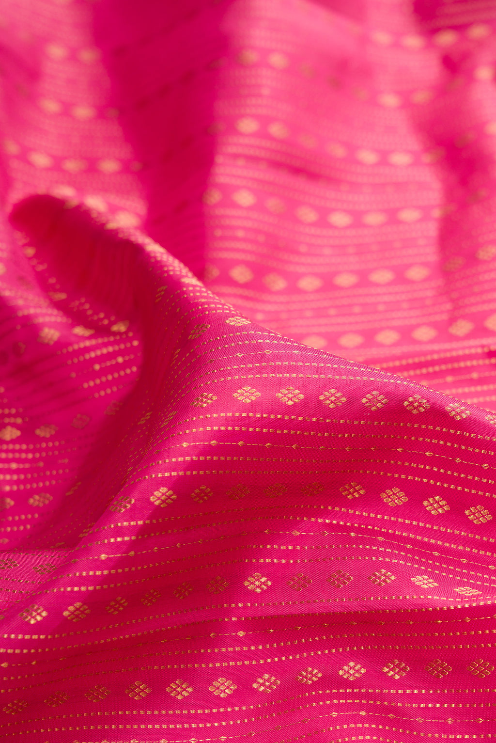 Close up of Pure Silk Pink Kanjivaram Saree with Stripes on the body and Zari Border.  displaying folds
