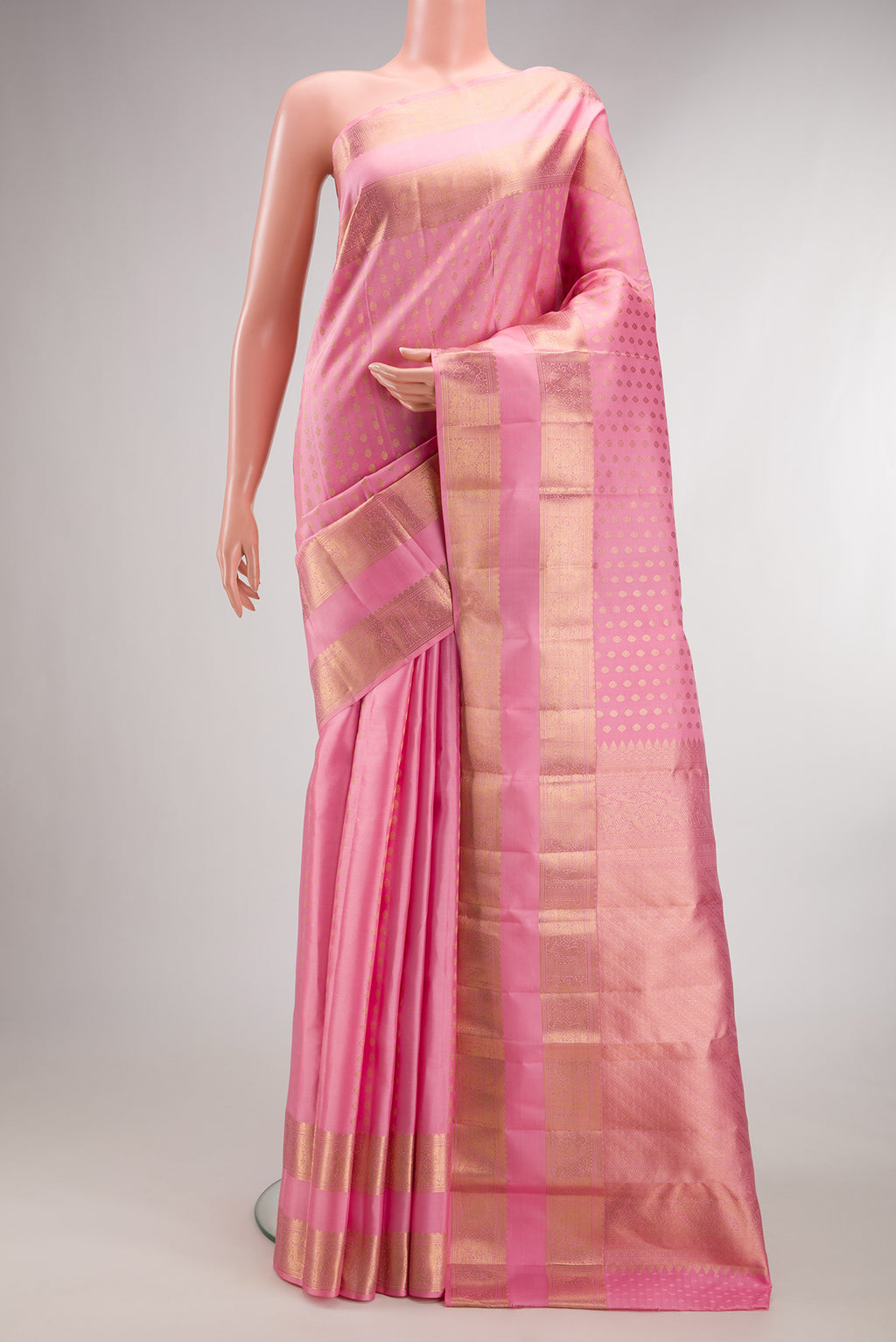 Pure Silk Rose pink Kanjivaram Saree with Zari Butta on the body and Zari Border.  displayed on a mannequin