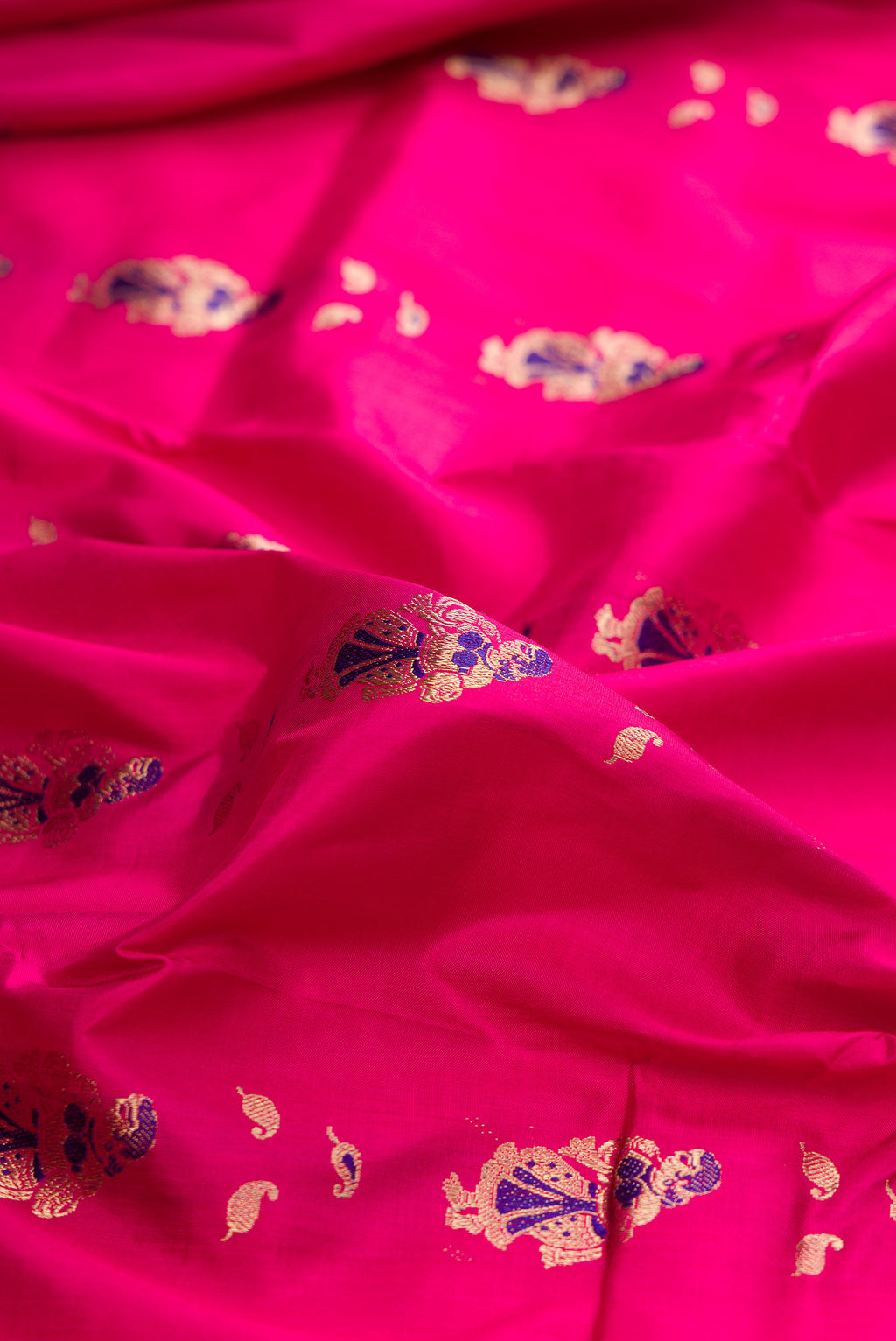 Close up of Pure Silk Pink Baluchari Saree with Zari And Thread Butta on the body and Zari And Thread Border.  displaying folds