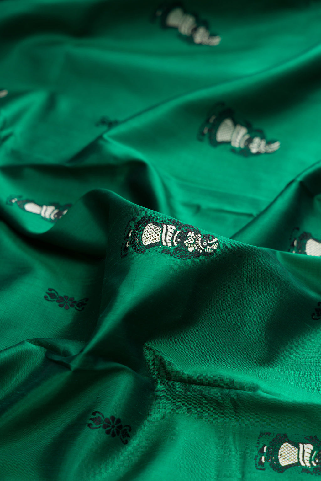 Close up of Pure Silk Green Baluchari Saree with Thread Butta on the body and Thread Border.  displaying folds