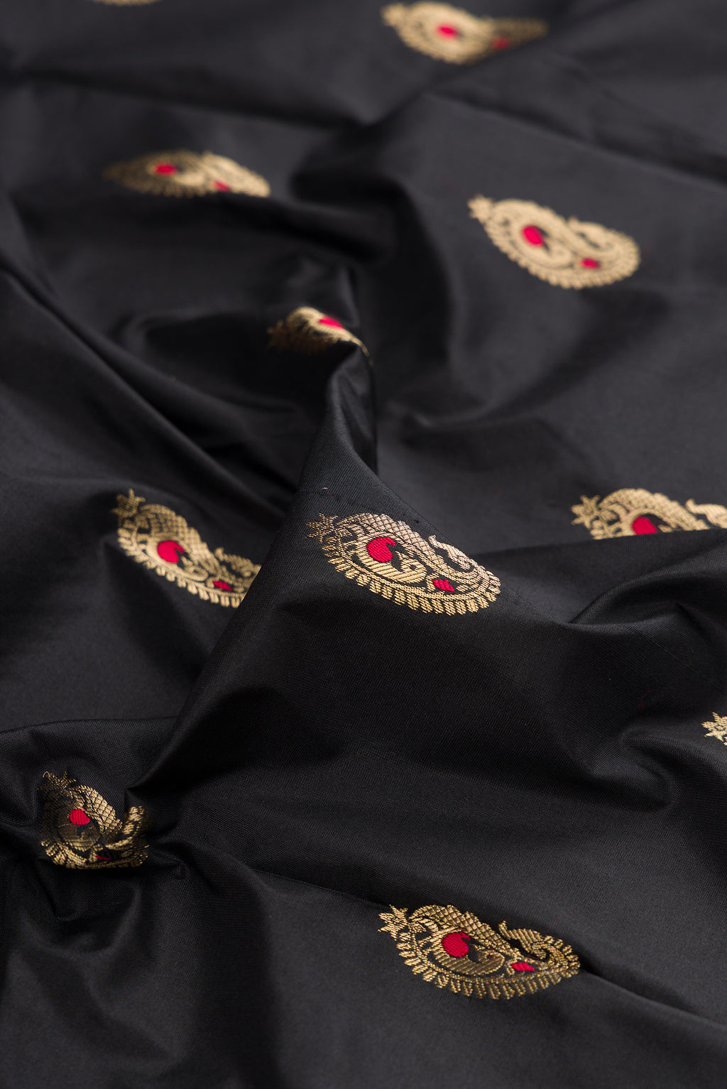 Close up of Pure Silk Black Dual Tone Paithani Saree with Zari And Thread Butta on the body and Zari Border.  displaying folds