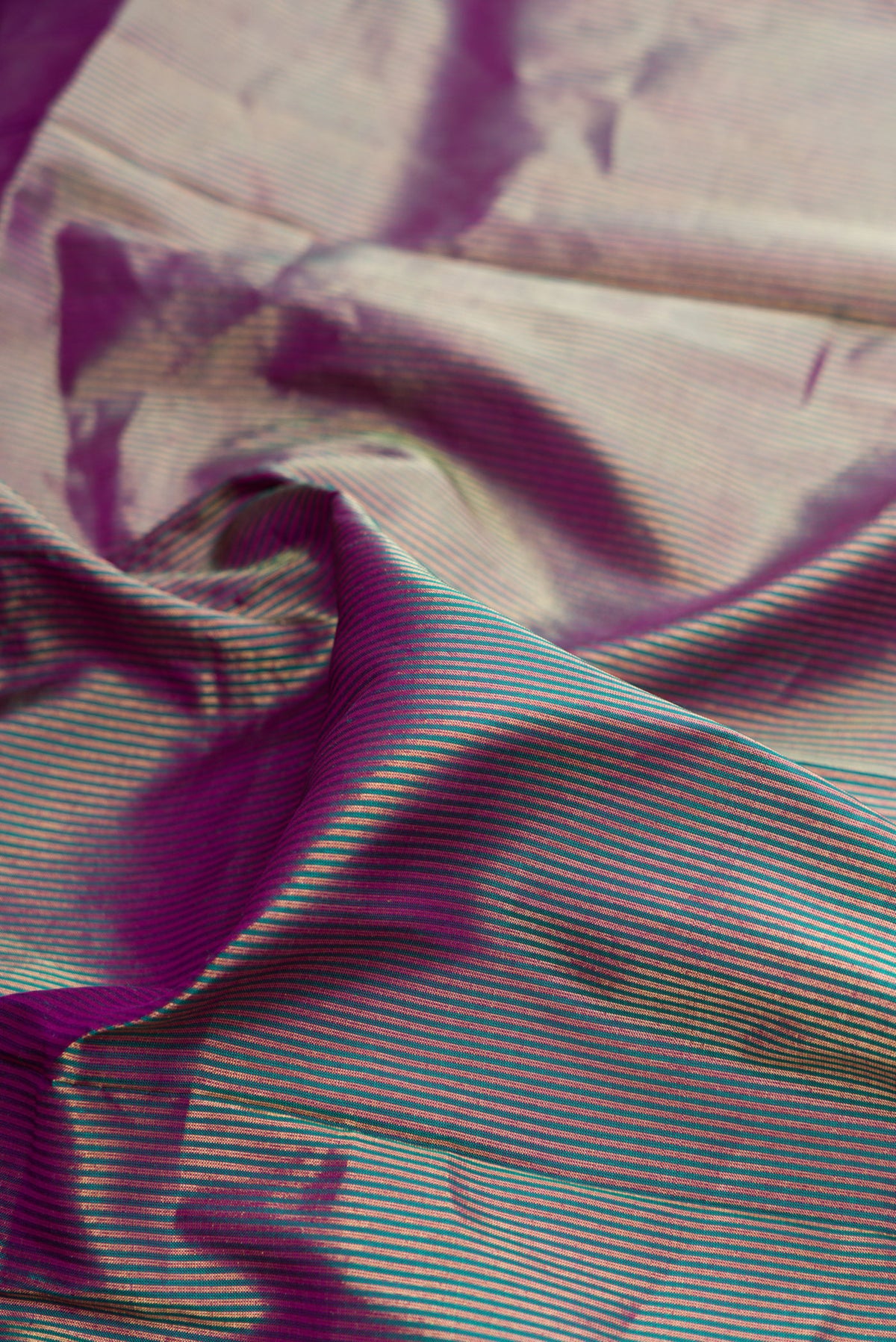 Close up of Pure Silk Purple Dual Tone Paithani Saree with Stripes on the body and Fancy Border.  displaying folds