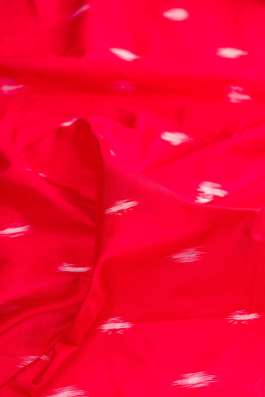 Close up of Pure Silk Red Pochampally Saree with Ikat design on the body and Ikat Border.  displaying folds