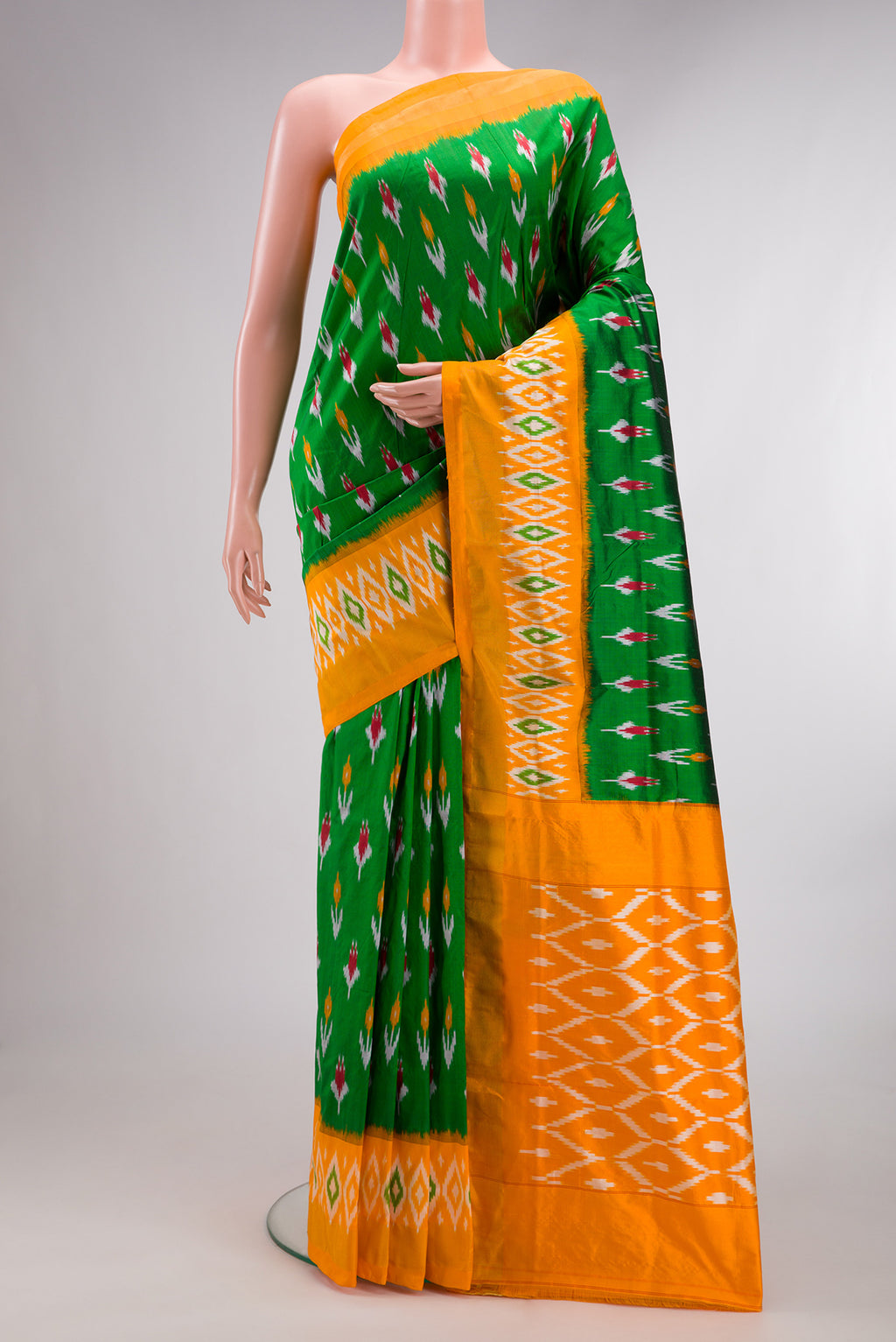 Pure Silk Green Pochampally Saree with Ikat Print on the body and Ikat Border.  displayed on a mannequin