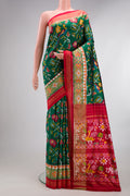 Pure Silk Bottle Green Dual Tone Double Ikat Saree with Ikat Print on the body and Ikat Border.  displayed on a mannequin