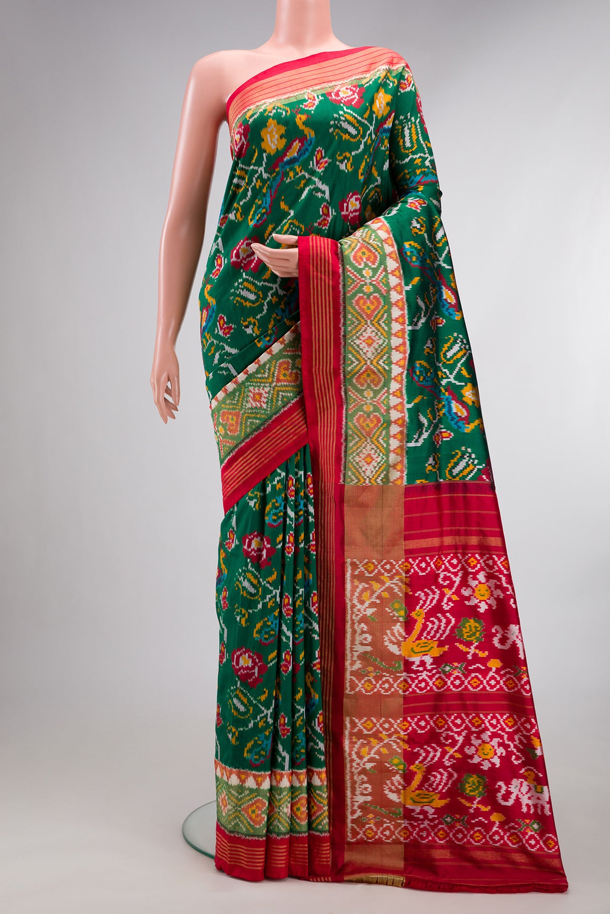 Pure Silk Bottle Green Dual Tone Double Ikat Saree with Ikat Print on the body and Ikat Border.  displayed on a mannequin