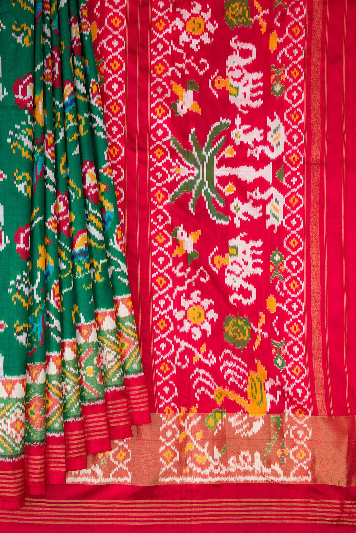 Pleats and pallu of Pure Silk Bottle Green Dual Tone Double Ikat Saree with Ikat Print on the body and Ikat Border. 