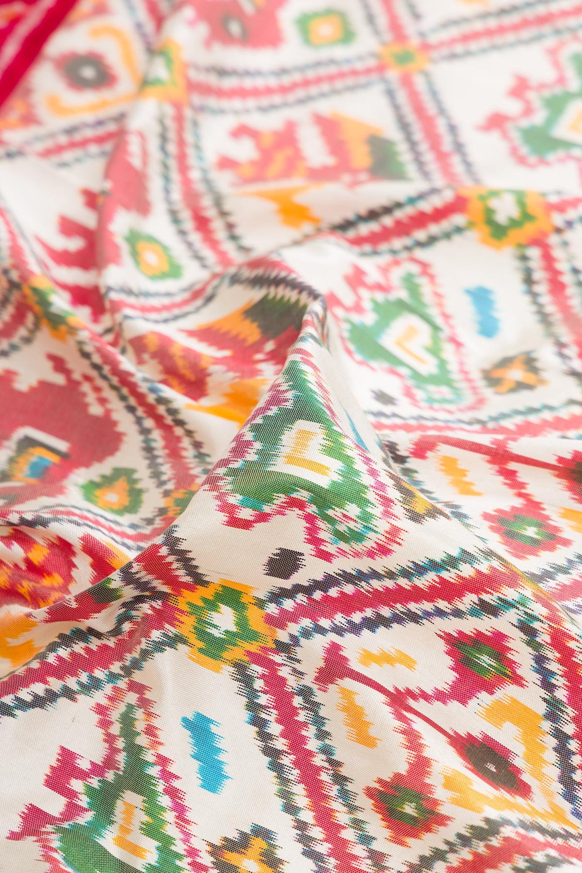 Close up of Pure Silk Off White Pochampally Saree with Pure Ikat on the body and Ikat Border.  displaying folds