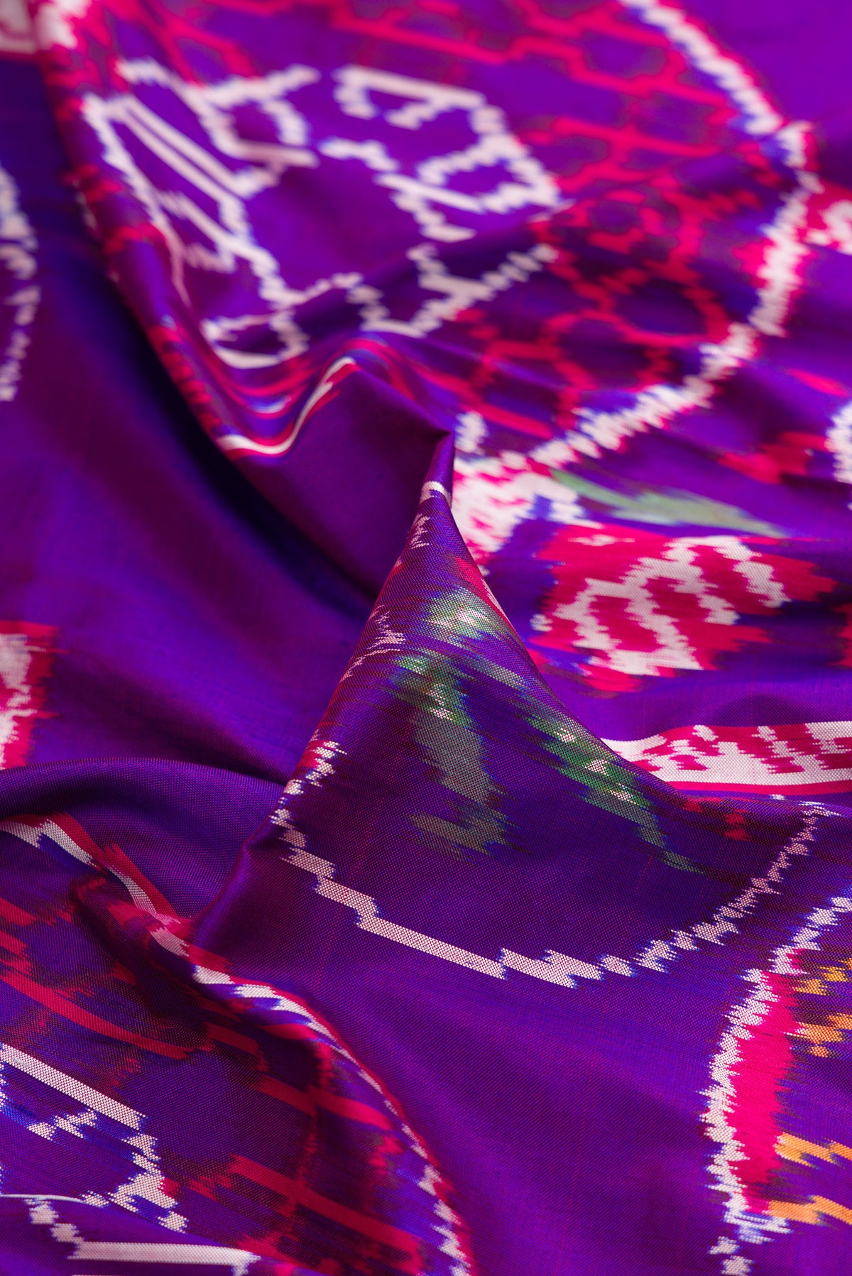 Close up of Pure Silk Purple Pochampally Saree with Pure Ikat on the body and Ikat Border.  displaying folds