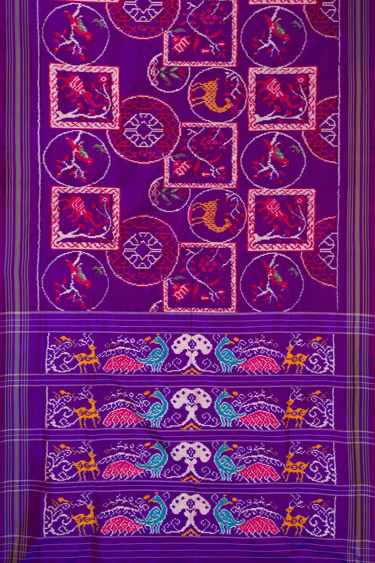 Flat view of Pure Silk Purple Pochampally Saree with Pure Ikat on the body and Ikat Border. 