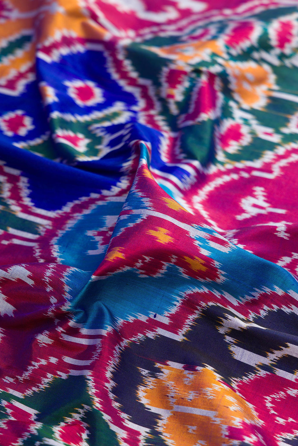 Close up of Pure Silk Multi Color Pochampally Saree with Pure Ikat on the body and Ikat Border.  displaying folds